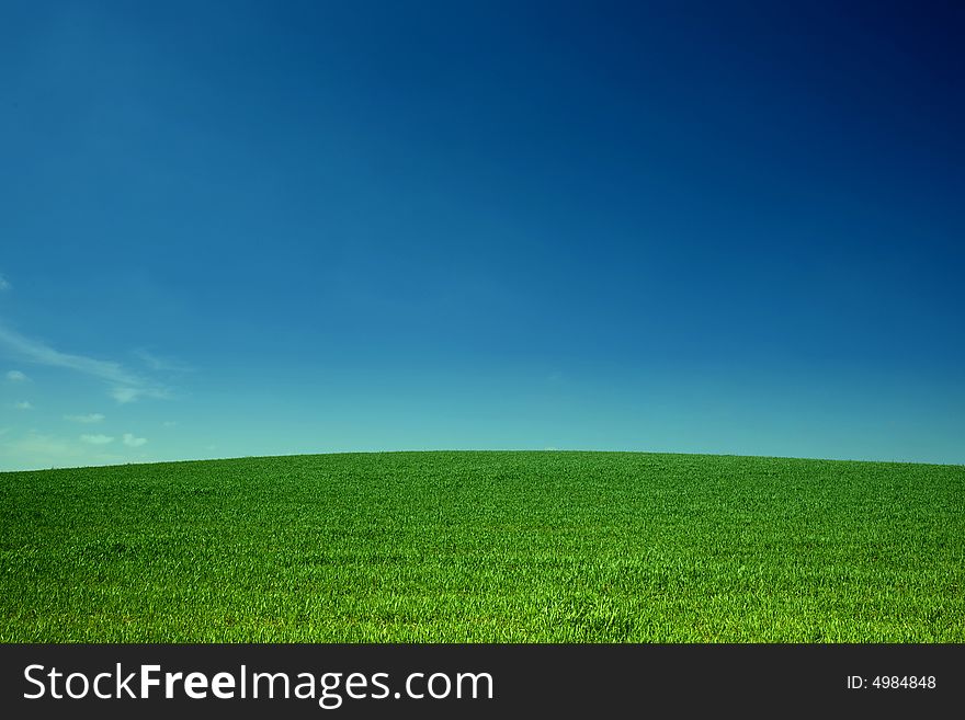 An image of sky over green field. An image of sky over green field