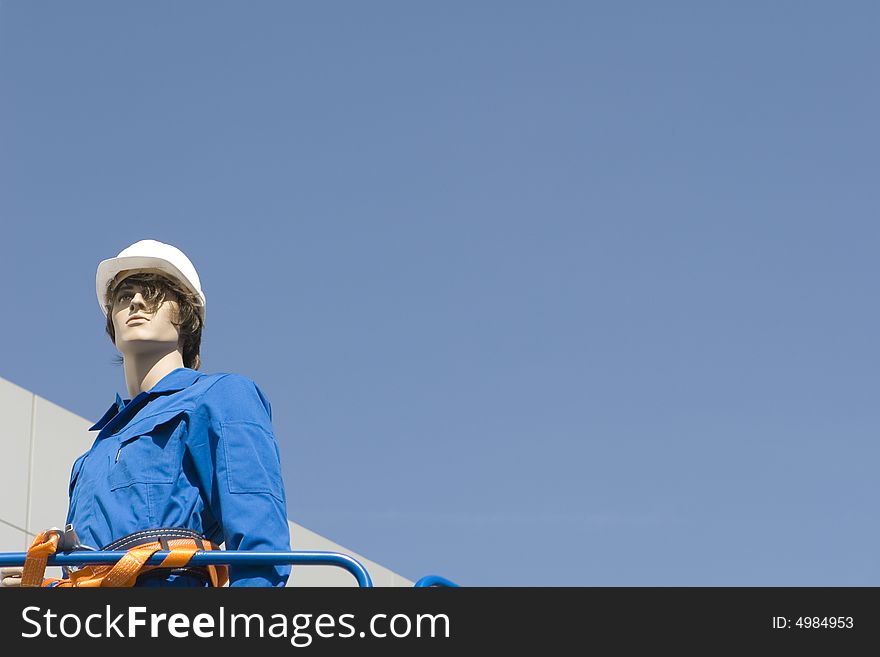 Dummy in building clothes on a background of the sky