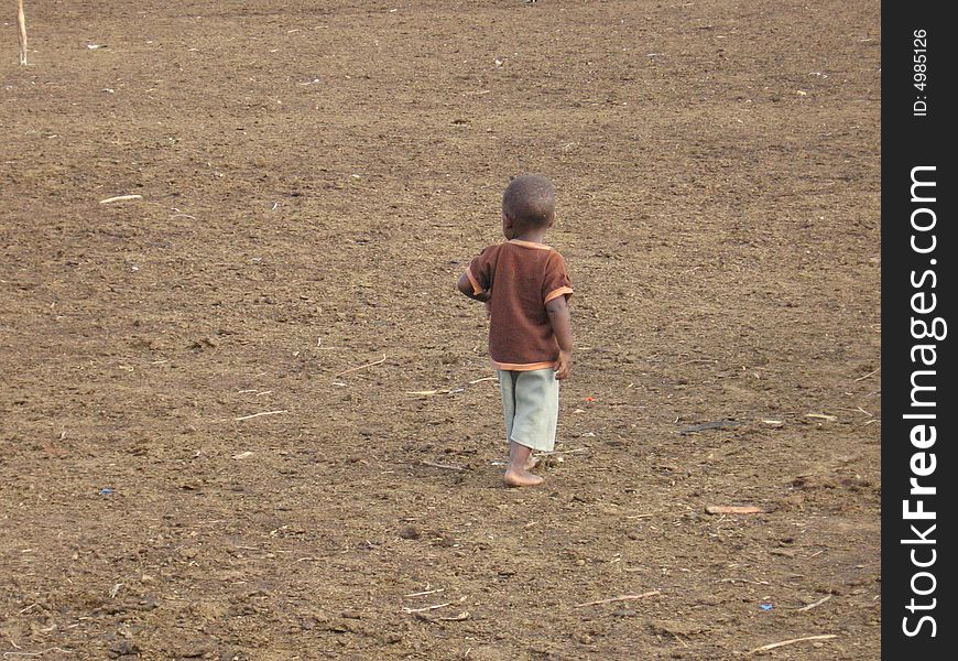 Little Maasai child in the village central square