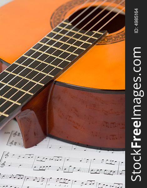 Acoustic guitar and sheet music, close-up