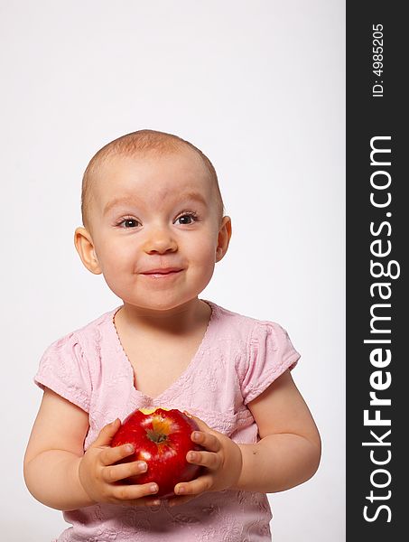 Portrait of happy baby with apple