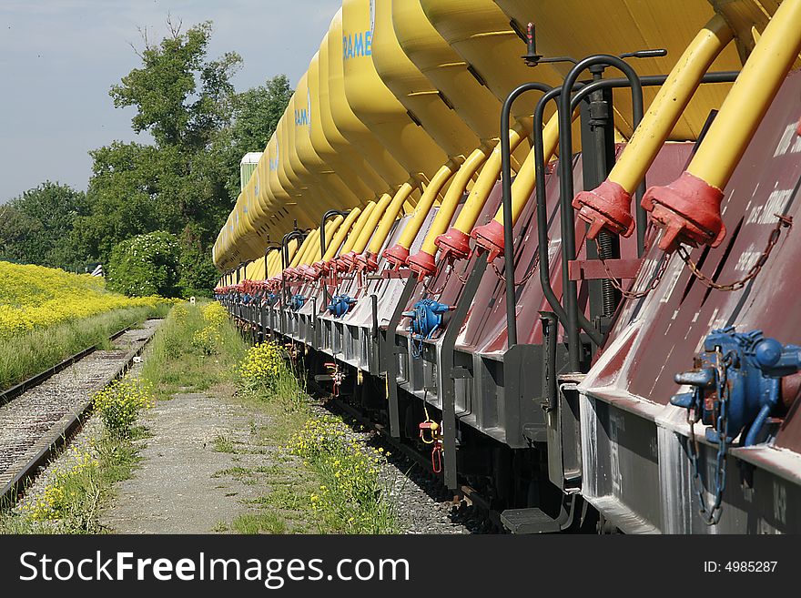 Rail transport with yellow silos in the port area photographed