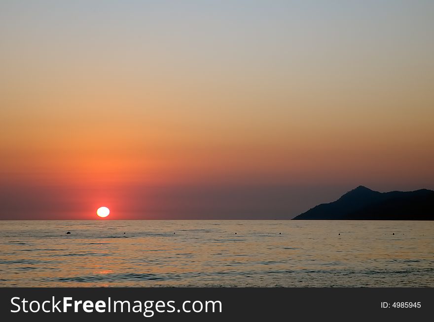 View from a beach red sunset over the Mediterranean sea