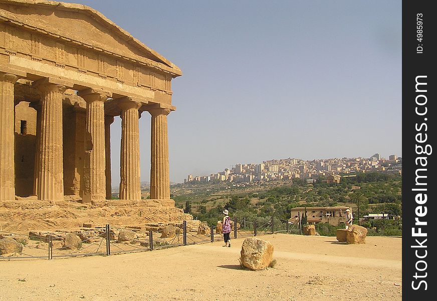 Ancient temple in front of the modern city of  Agrigento. Ancient temple in front of the modern city of  Agrigento