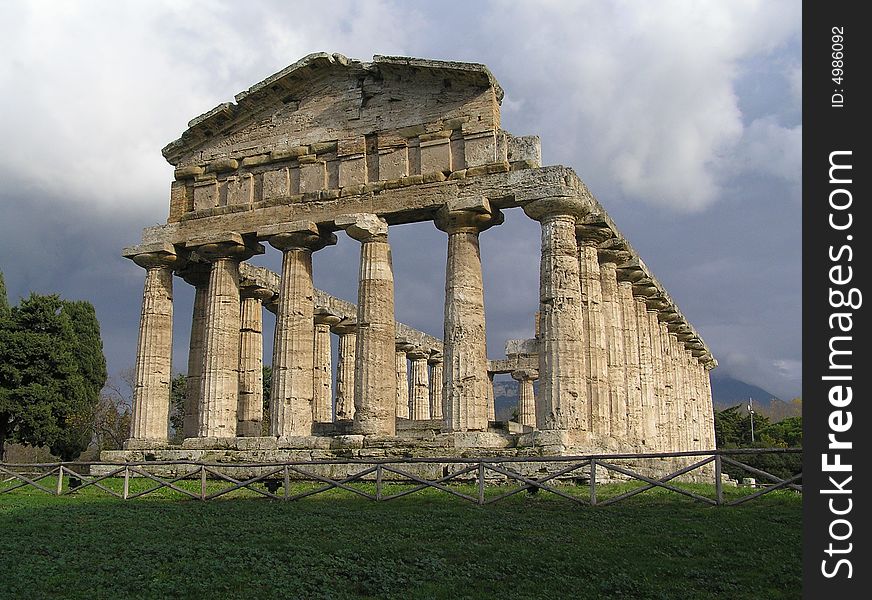 Dark clouds hanging over one of the ancient temples of Paestum, Italy