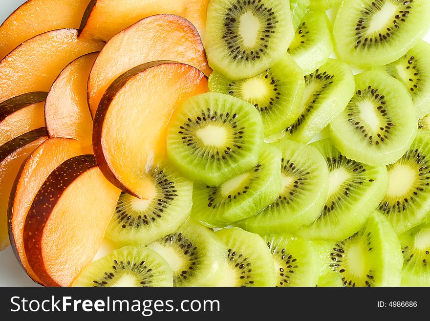 Background from sliced kiwi and plums. Background from sliced kiwi and plums.