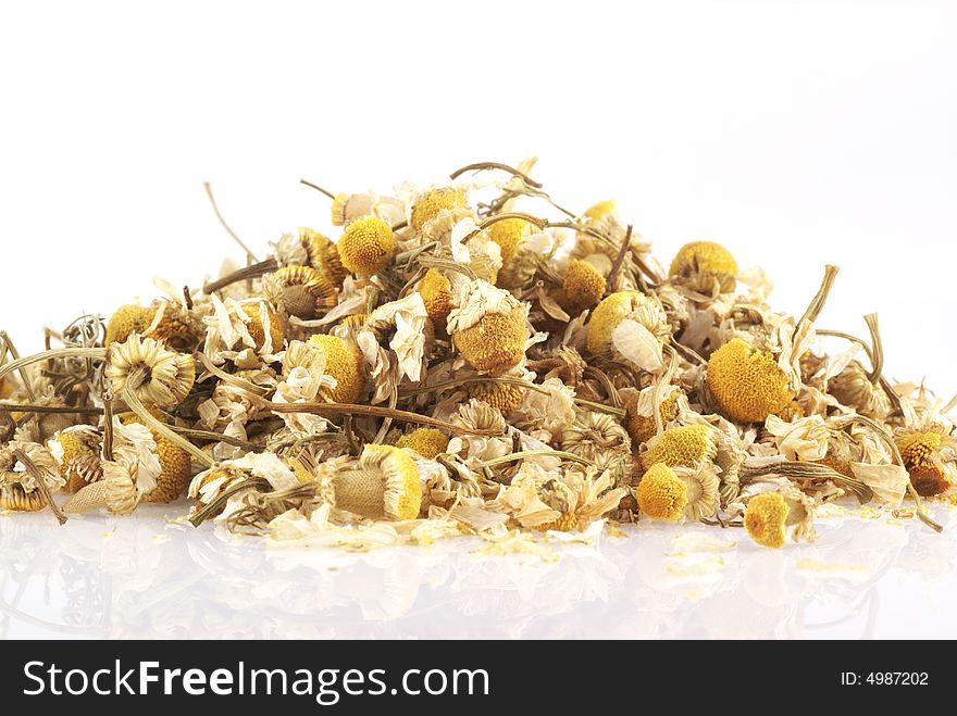 Dried chamomile on a white background. Dried chamomile on a white background.
