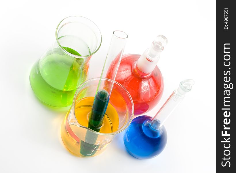 Various colorful flasks over white background