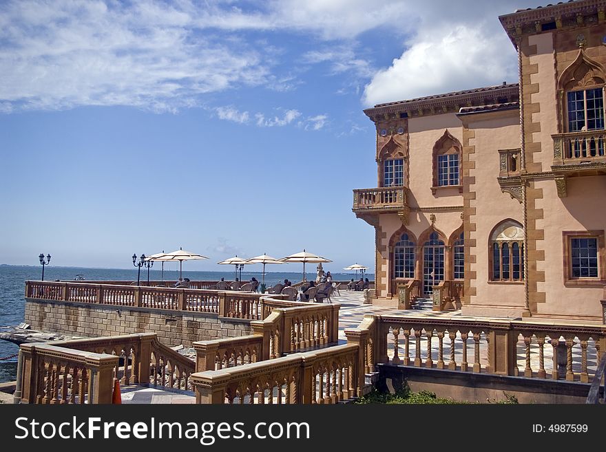 People relaxing on a grand terrace, or Palazzo. People relaxing on a grand terrace, or Palazzo.