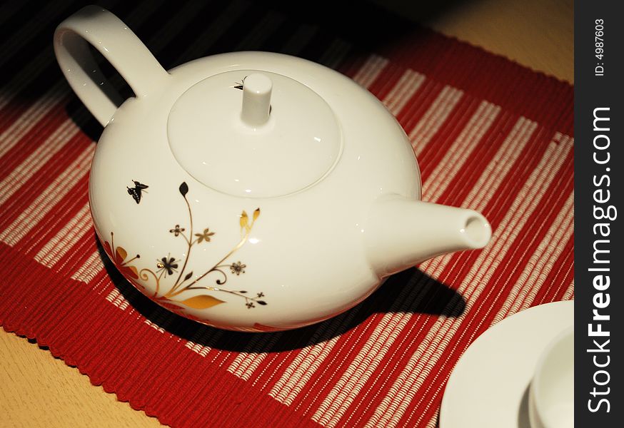 White teapot with beutiful flower pattern