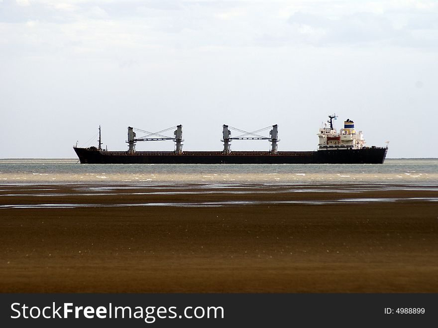 Big cargo ship very close to the shore