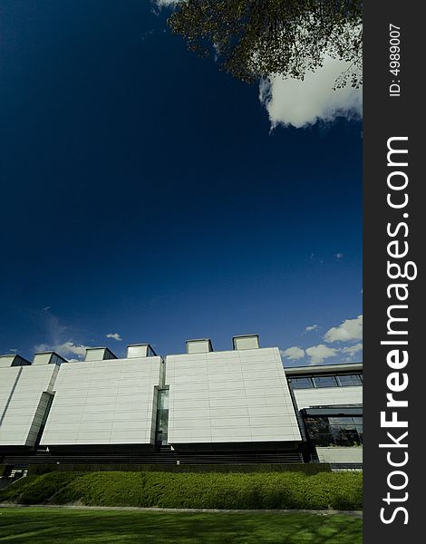 Wide view of a modern building, copy space on the deep blue sky area. Wide view of a modern building, copy space on the deep blue sky area.