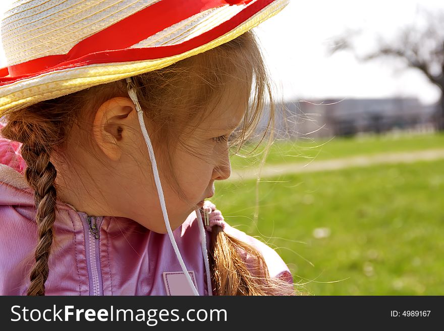 Little girl with hat at park. Blur  background. Spring time. Little girl with hat at park. Blur  background. Spring time.