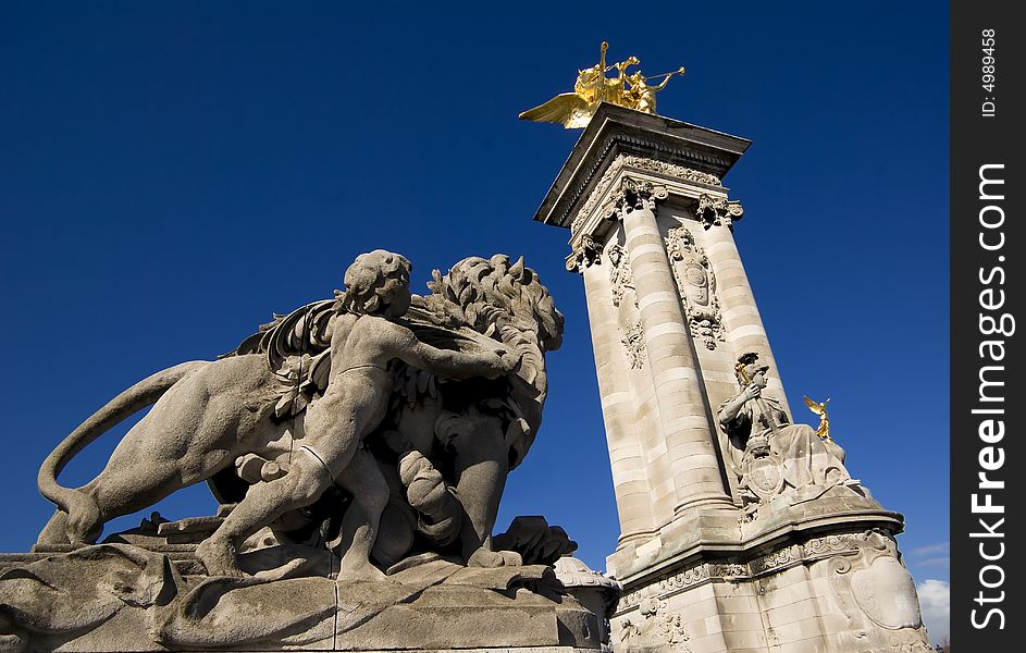 Stone statues on the Pont Alexandre bridge against a brilliant blue Spring sky. Stone statues on the Pont Alexandre bridge against a brilliant blue Spring sky.