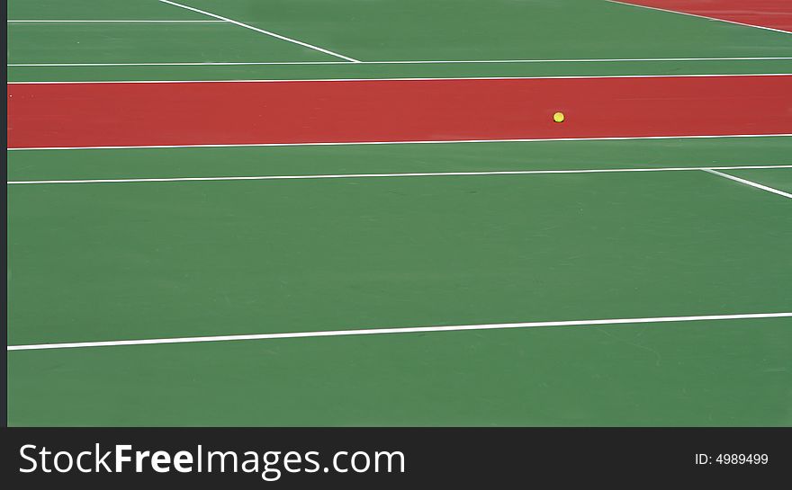 View of two tennis courts with a yellow ball. View of two tennis courts with a yellow ball