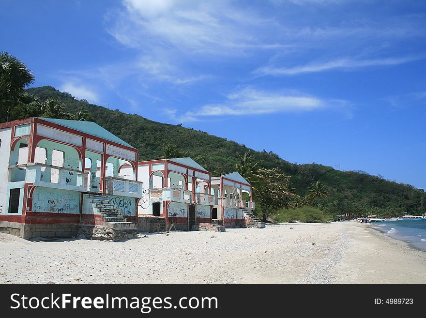 Deserted hotel on beach with graffiti