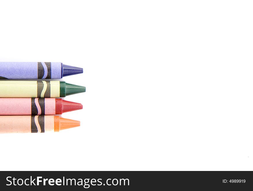 Four colored crayons on a white background. Four colored crayons on a white background