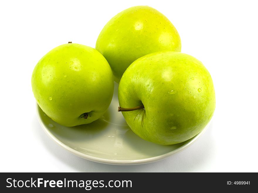 Tree green apples on a plate on white background. Tree green apples on a plate on white background