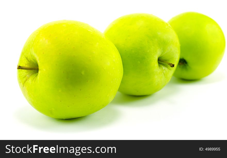 Three green apples isolated on white background