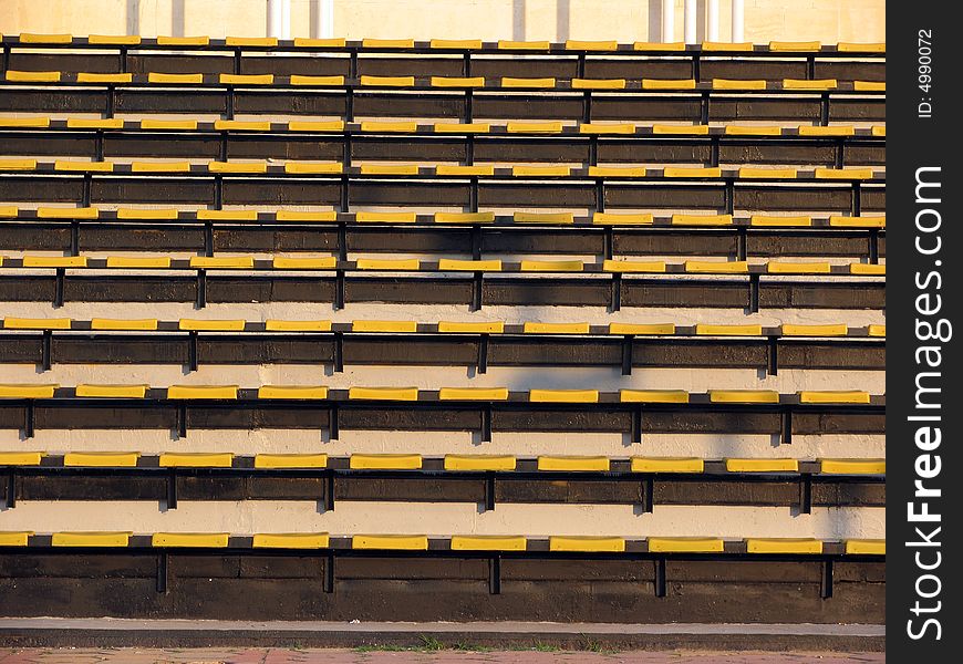 Empty yellow seats in a stadium. Empty yellow seats in a stadium