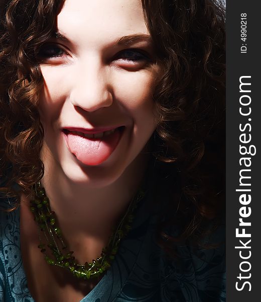 A portrait about a pretty lady with white skin and long brown wavy hair who is mocking. A portrait about a pretty lady with white skin and long brown wavy hair who is mocking