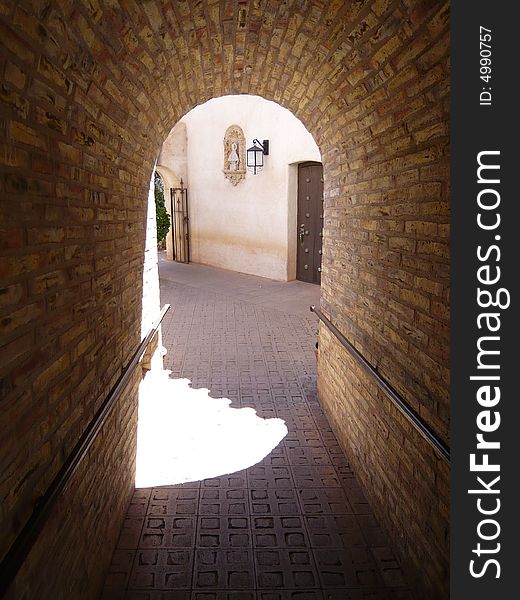 Photograph of a archway over a walking path in an old town. Photograph of a archway over a walking path in an old town.