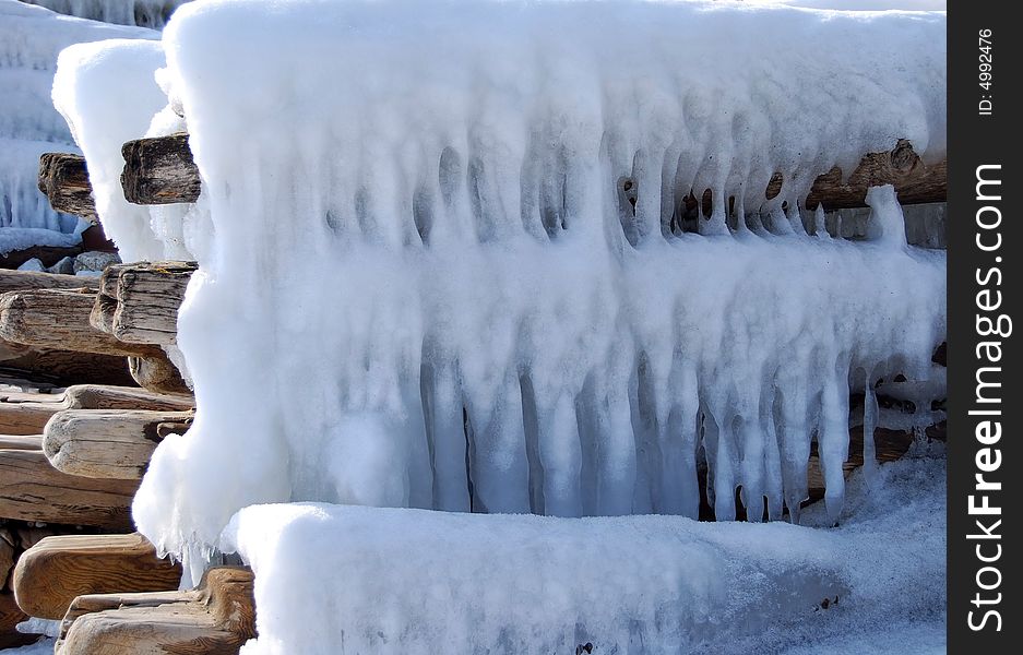 Part of the frozen wooden construction covered by ice and snow