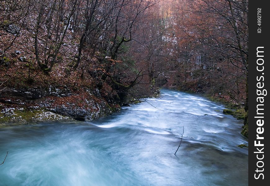 River flowing through small canyon in late fall