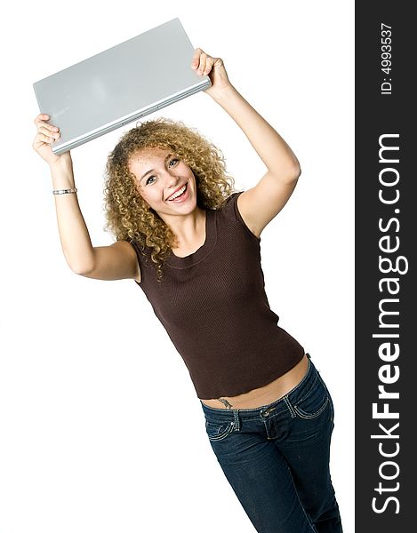 A beautiful young women holding her portable computer above her head. A beautiful young women holding her portable computer above her head