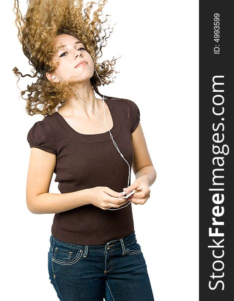 A beautiful young girl flicking her hair back to the music. A beautiful young girl flicking her hair back to the music