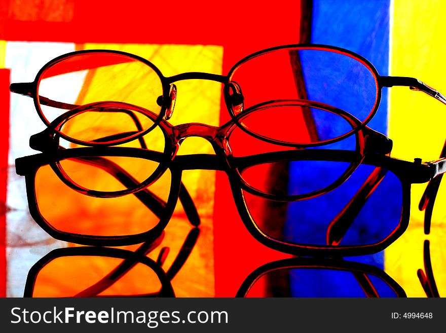 Abstract background design made from a stack of eyeglasses and numerous colors. Abstract background design made from a stack of eyeglasses and numerous colors.