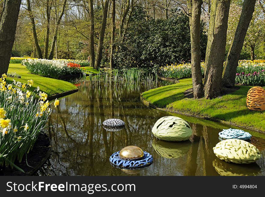 View on dutch garden with pond and art decoration. View on dutch garden with pond and art decoration