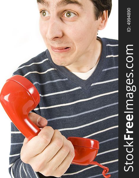 Young man holding red telephone receiver