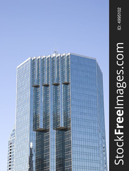 A modern blue glass office building with many angles. A modern blue glass office building with many angles