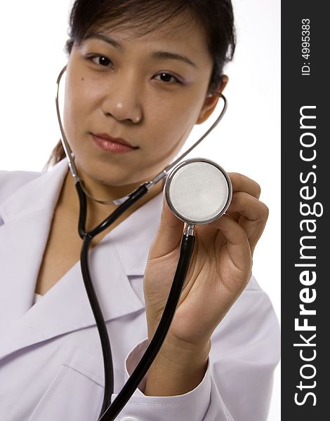 Female doctor holding a stethoscope in white background. Female doctor holding a stethoscope in white background.