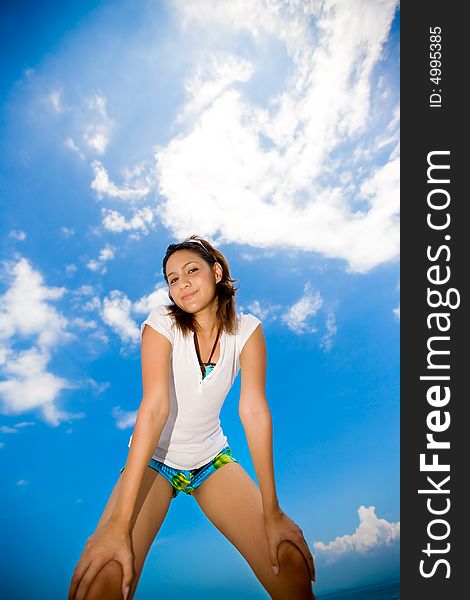 Woman looking down on summer time with bright blue sky on the back. Woman looking down on summer time with bright blue sky on the back
