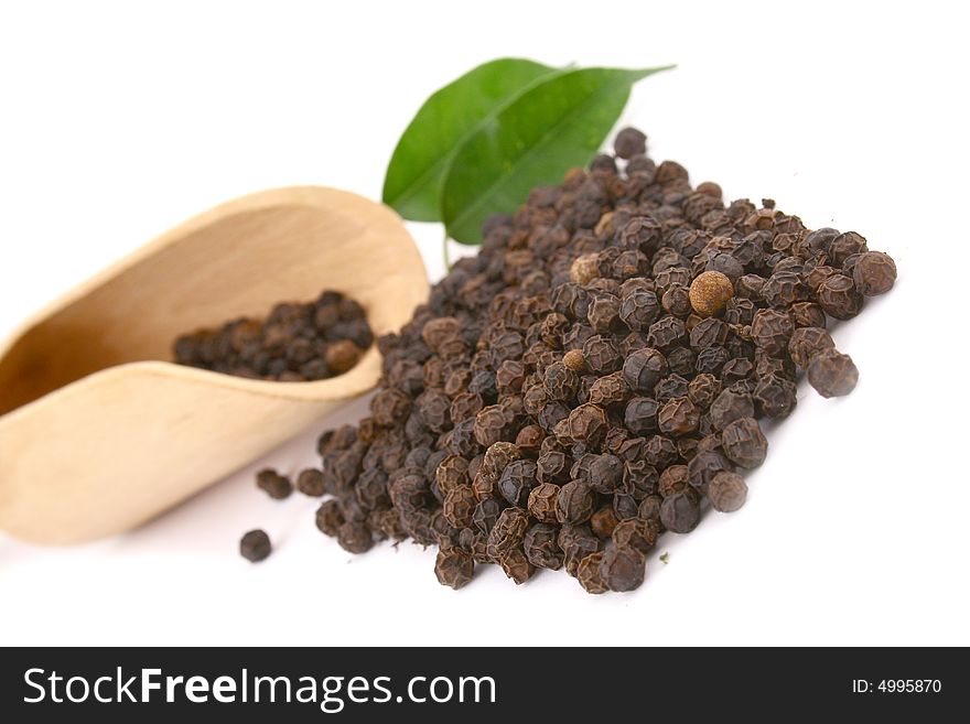 Closeup peppercorns in wooden and white backgrund