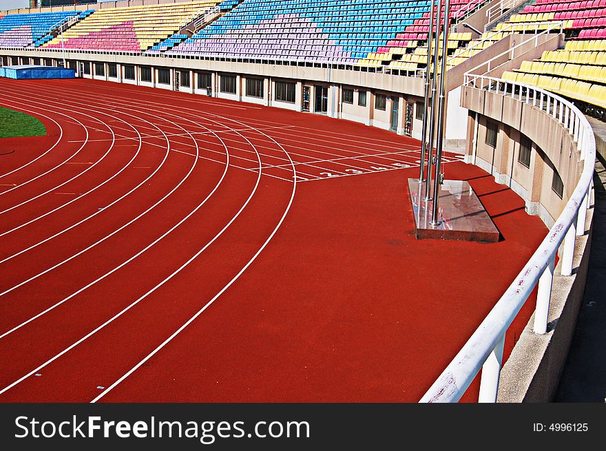 Bright red runway, multicolored and neat gallery seats,green lawn ,with bright sunshine.Life depends on sports.happiness lies in giving.More sports exercises,more healthy. Bright red runway, multicolored and neat gallery seats,green lawn ,with bright sunshine.Life depends on sports.happiness lies in giving.More sports exercises,more healthy.