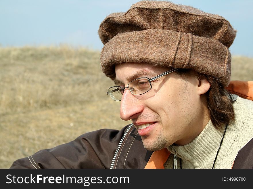 Portrait of man in hat on background of nature. Portrait of man in hat on background of nature