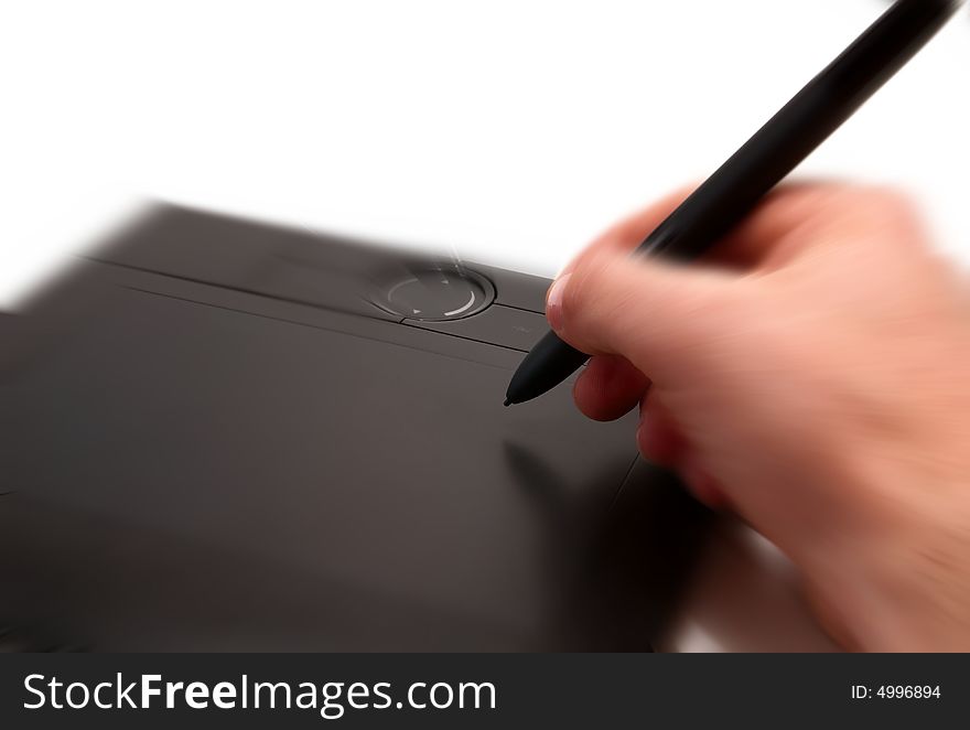 A human hand holding pen on graphic tablet for computer. A human hand holding pen on graphic tablet for computer.