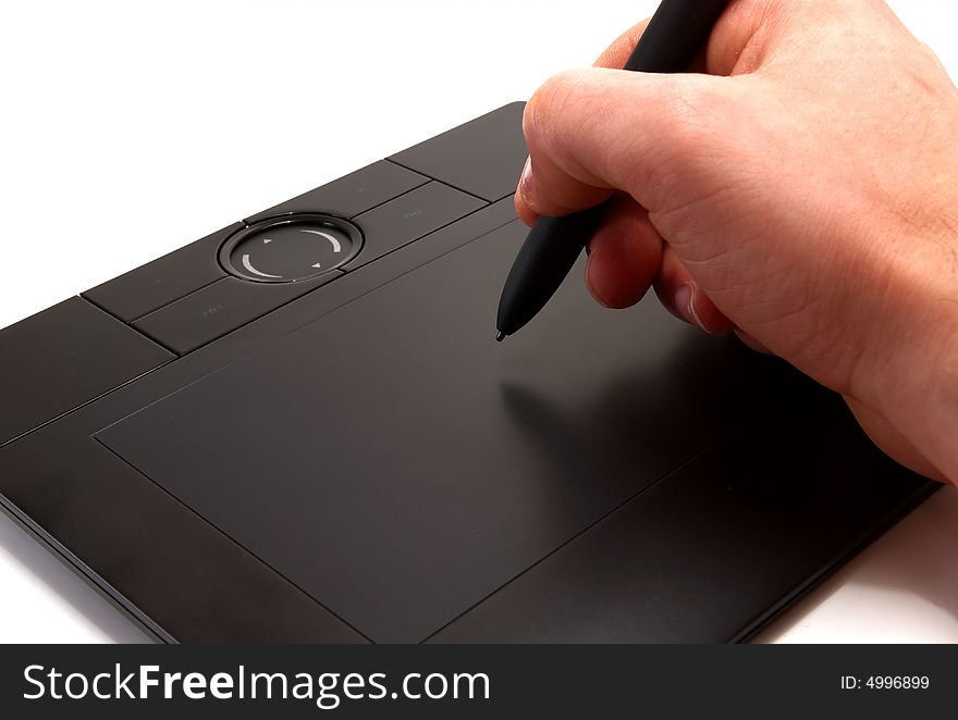 A human hand holding pen on graphic tablet for computer. A human hand holding pen on graphic tablet for computer.