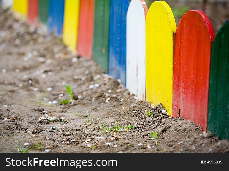 Colorful wooden fence of small garden