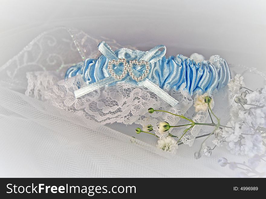 Blue wedding garter on ribbon and tulle. Blue wedding garter on ribbon and tulle.