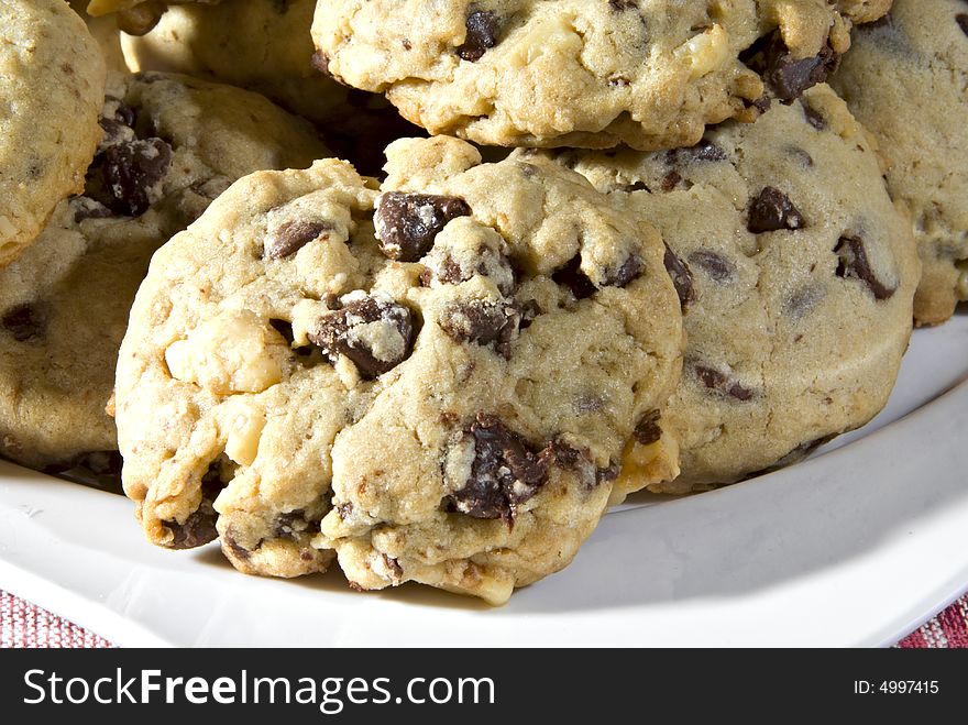 A plate of cookies with chocolate chips and nuts. A plate of cookies with chocolate chips and nuts.