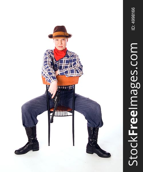 Cowgirl with gun siiting on chair and glares down upon all with the utmost contempt (isolated on white)