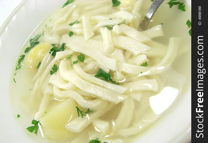 Hot chicken soup bouillon in white dish. Hot chicken soup bouillon in white dish