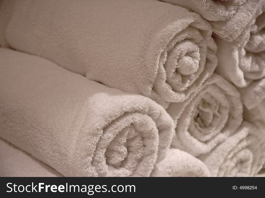 Soft and fluffy white towels in a stack with room for copy. Soft and fluffy white towels in a stack with room for copy.