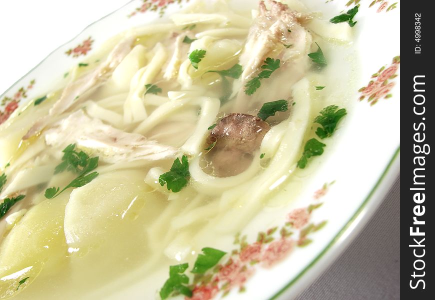 Hot chicken soup bouillon in white dish. Hot chicken soup bouillon in white dish