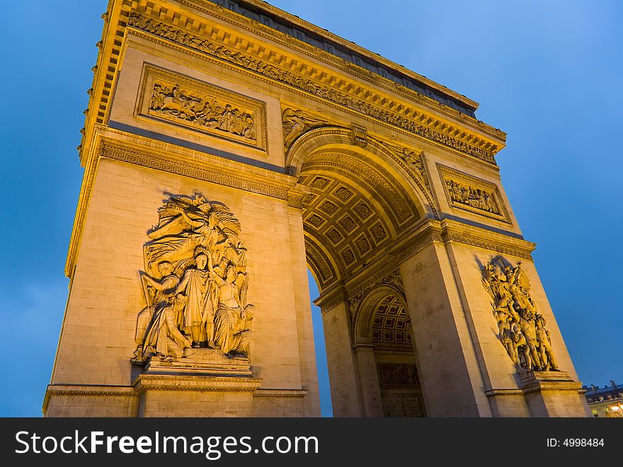 Late evening photograph of floodlit Arc de Triomphe. Late evening photograph of floodlit Arc de Triomphe.