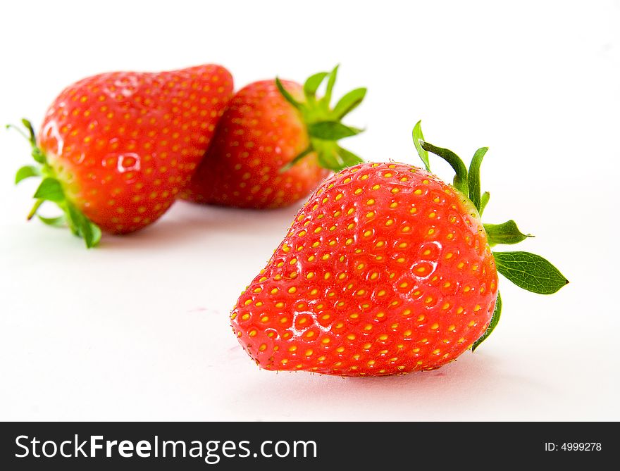 Three strawberry over white background